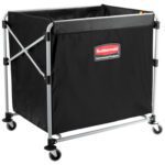 The Rubbermaid® Collapsible Basket Truck - 8 Bushel is a black, rectangular industrial laundry cart with a metal frame, four swiveling wheels, and features a Rubbermaid Commercial Products logo on one side. It offers reinforced corners and a spacious interior for durability and capacity.