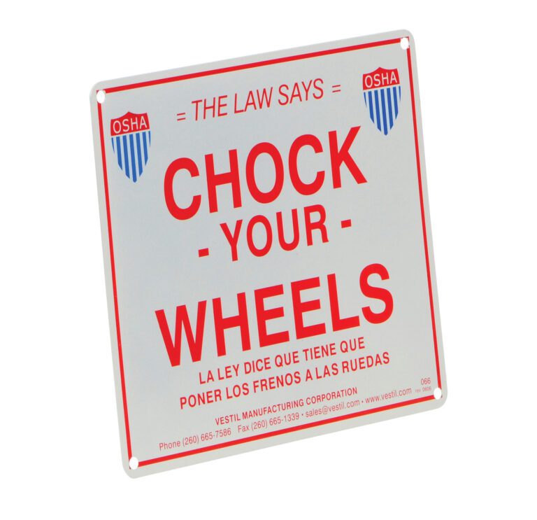 The square safety sign displays The Law Says Chock Your Wheels in English and Spanish with OSHA logos, featuring the Vestil Aluminum Enamel Wheel Chock Sign 9.75 In, and includes Vestil Manufacturing Corporations contact details at the bottom.