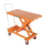 The Vestil Steel Auto-Hite Cart with an 800 lb capacity has an orange finish, a flat rectangular platform, white handlebars, four wheels, and an X-shaped support. It also includes a foot pedal for easy lifting.