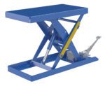 Shown is a 20X40 blue Vestil Scissor Lift Table with hydraulic mechanism and foot pump. It features a yellow support on one side, holds up to 1000 lbs, and has a sturdy design for various tasks.