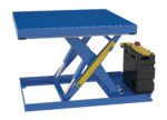 The Vestil Scissor Lift Table 42X42, with a 2000 lb capacity and 12DC power, features a blue hydraulic design. It also has a yellow support bar, black control unit with a red emergency stop button on the right, and is partially extended.