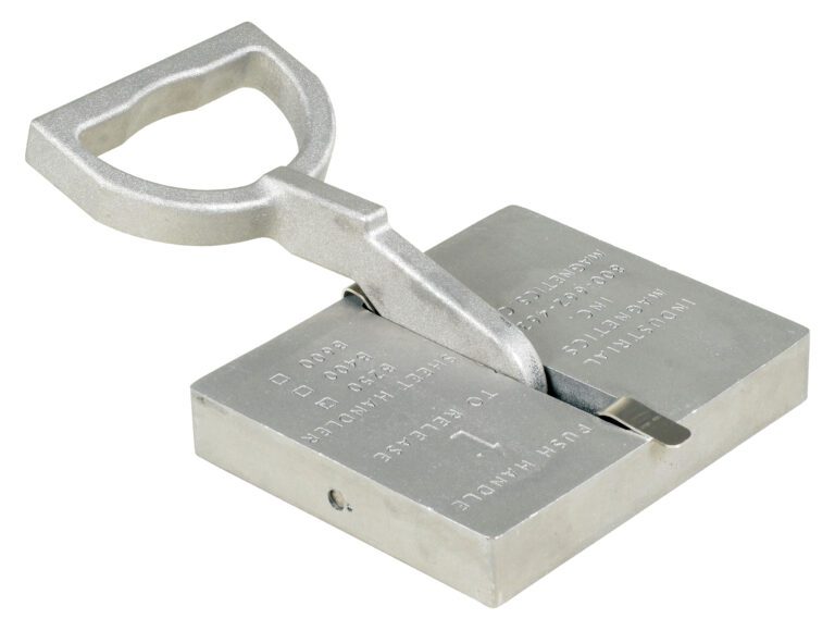 Image of a large metal tag punch tool with a rectangular base and angled handle, similar to the sturdy design of the Vestil Sheet Handler 125 Lb Working Capacity. Its engraved surface markings enable it to emboss letters or numbers onto metal tags efficiently.