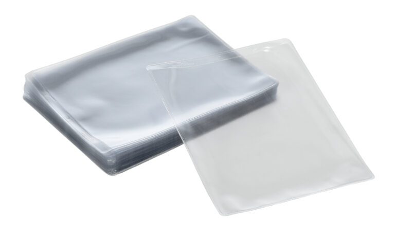 SHOPT-P_A.jpg A stack of clear, rectangular plastic laminating pouches, with one pouch slightly open, sits elegantly against a white background, echoing the sleek design of Vestil Standard Shop Ticket Holders.