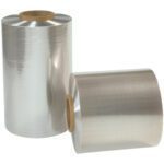 Two large rolls of 8 x 60 Gauge x 2500 Reynolon® 5044 PVC Shrink Film (2 Rolls/Case) appear against a white background, one upright and the other on its side, both featuring a brown cardboard core.