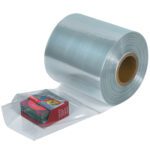 The MH-USA 10 x 100 Gauge x 1500 Shrink Tubing roll cradles colorful boxes, its core visible as the glossy tubing shimmers against a plain background.