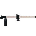 An MH-USA Carton Sizer/Reducer is a precision balance scale with a long horizontal beam, marked for measurements. It features an adjustable central slider and two black weight components, with black base and supports contrasting the beams white background.