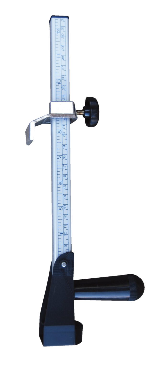 The Vestil Box Sizer Cutter 13 In Height is silver and black with a vertical scale, adjustable knob, sturdy base, and a metal slider for precise measurements.