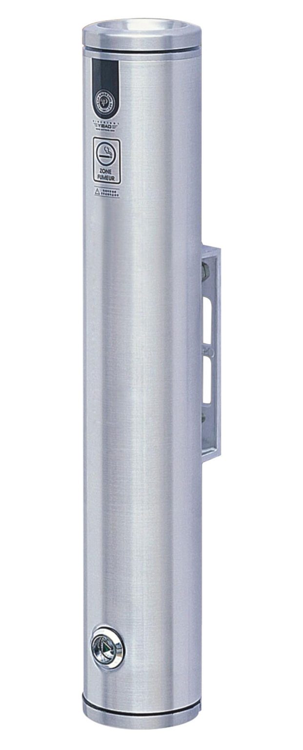 The Vestil Bollard-Smokers-Aluminum 19 In is a wall-mounted, cylindrical stainless steel ashtray with a top slot for cigarette disposal and a bottom lock. It features clear instructions and symbols near the top for easy use.
