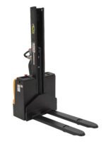 The Vestil Stacker Pwr Lift/Dr 21 In Fix Frk 62 In features a distinctive black and orange design, two long metal forks for pallet lifting, and a side control handle with safety and operational labels that contrasts against its clean white background.