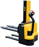 The yellow and black Vestil Stacker electric pallet jack, named the Vestil Stacker Pwr Lift/Dr 21 Frk 43In 3000 Lb, features a handle and dual prongs ideal for lifting palletized loads in warehouses or factories. The brand label partially appears on the side, showcasing its sturdy 3000 lb capacity.