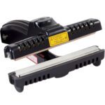 The MH-USA 6 Crimper Hand Sealer is a handheld device with a ridged handle, designed for efficient fabric pressing, featuring metal heating elements and a warning label on its head.