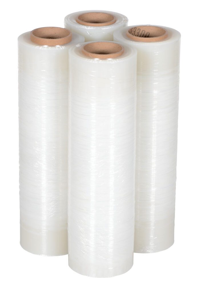 Four rolls of clear plastic wrap, similar to Vestil Film For Hand Held Wrapper 1500 Ft, stand upright against a white background. Each is shiny and tightly wound around sturdy brown cardboard cores.