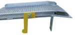 A metal loading dock leveler with a perforated surface and yellow side safety latch, featuring a curved edge with a downward lip similar to the durable design of the Vestil Aluminum Dockboard W/ Sliding Span Locks.