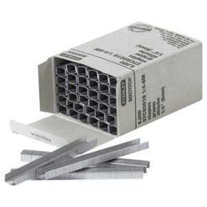 An open box of MH-USA 1/4 Deluxe Staples (6000/Case) displays a neat hexagonal pattern inside and several silver staples scattered in front, with packaging labeled for product and brand details.