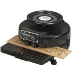 The Marsh® 1/2 Stencil Machine, with a black vintage design, features a circular wheel, hand crank, and brown embossed letter strip. It includes a flat platform for easy material feeding.