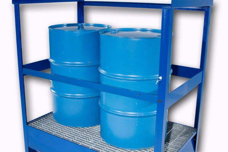 Two blue metal barrels are secured on a gray grate within a sturdy blue storage rack enhanced by the Vestil Drum Pallet - Security Bar Option, offering extra stabilization with horizontal bars.
