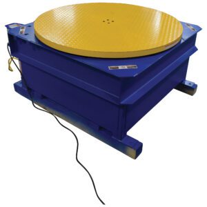 The Vestil Chain Driven Ac Carousel 4K Lb 48 In Dia features a sturdy blue design with a textured yellow circular top, flat square base, and side power cord, ideal for heavy-duty applications.