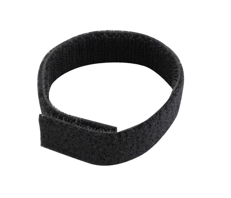A black Velcro cable tie forms a circle with its fastening end slightly overlapping, similar to the versatile Vestil Strap With No Loop - 150 Pcs. Its texture has fine loops and hooks for a secure hold.