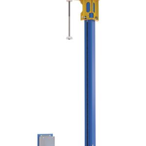 A tall blue and yellow Vestil Wrap Machine component with a metal rod stands beside a smaller blue metallic panel. This setup may be part of an industrial system, possibly featuring the Vestil Optional Retrofit Power Mast for enhanced functionality.