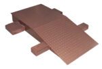 The Vestil Steel Wheel Riser 60L X 24W X 10.25H is a brown metal wheelchair ramp with a diamond plate surface, featuring a sloped section and flat landing area supported by rectangular side blocks for stability and durability.