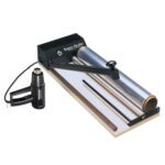 The MH-USA 24 Super Sealer System includes a tabletop heat sealer with a Super-Sealer black arm, transparent shrink film roll, and a convenient heat gun, perfect for efficient packaging sealing or wrapping.