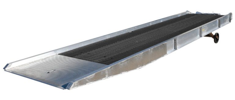 The Vestil Alum Yard Ramp Steel Grating 95 Inx30 Ft is a long, metallic ramp with textured non-slip surface and side rails. It features steel grating for durability, has a slight incline, wheel for mobility, and is ideal for loading/unloading vehicles.