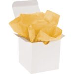 A white gift box with the lid open displays crumpled MH-USA 20 x 30 Buttercup Gift Grade Tissue Paper (480 Sheets) in vibrant yellow.