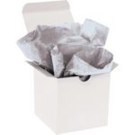 An open white gift box displays crumpled MH-USA 20 x 30 Metallic Silver Gift Grade Tissue Paper (200 Sheets), sparkling gently in the light.