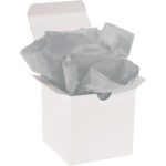 A white gift box with an open lid is elegantly filled with MH-USA 20 x 30 Light Gray Gift Grade Tissue Paper, creating a soft and stylish presentation.
