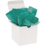 A white gift box with a partially open lid reveals crumpled MH-USA 20 x 30 Teal Gift Grade Tissue Paper (480 Sheets). The elegant teal contrasts beautifully against the plain white background, hinting at the surprise within.