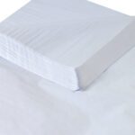 A stack of MH-USA 24 x 36 White Gift Grade Tissue Paper (960 Sheets) with slightly curled edges sits neatly aligned on a flat surface, the top sheet slightly tilted to display its smooth and clean texture.