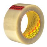 A roll of 2 x 55 yds. clear packing tape from the 3M™ 351 Carton Sealing Tape (6 Pack) includes a yellow core with red plaid strip and printed text, designed for efficient box sealing.