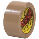 The 2 x 55 yds. Tan Scotch® Box Sealing Tape 375 (6 Pack) has a glossy tan finish and the inner core features a yellow and red plaid pattern with Scotch printed repeatedly.
