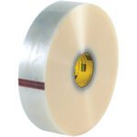 A large roll of 3 x 1000 yds. Clear 3M™ 371 Carton Sealing Tape (4/Case), featuring a yellow inner core and red stripe, stands upright against a white background, providing durability and reliability for packaging needs.