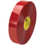 A roll of clear adhesive tape with a yellow core stands upright against a white background. The glossy finish, similar to 2 x 1000 yds. Clear 3M Security Message Box Sealing Tape 3779, beautifully reflects light on its surface.