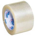 A case of 24 rolls of 3 x 110 yds. Clear Tape Logic® Lbs220 industrial tape features a white core with a blue and red logo, offering a glossy, transparent adhesive surface that unwinds smoothly.