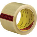 A roll of clear adhesive tape with an inner red plaid strip and yellow core labeled Scotch, from the 3 x 55 yds. Clear (6 Pack) 3M™ 3743 Carton Sealing Tape collection, showing both roll and adhesive side.