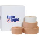 Four rolls of brown adhesive tape in varying sizes are stacked before a white tape logic box, with the largest at the back. Opt for the 72mm x 375 White Tape Logic® Lbs7200 Reinforced Water Activated Tape (8 Rolls/Case) for a tougher seal.