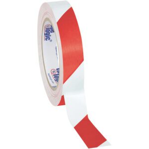 A roll of 1 x 36 yds. Red/White Tape Logic® Striped Vinyl Safety Tape (48 Rolls/Case) stands partially unrolled upright on a white background, displaying its diagonal pattern with indistinct branding visible on the inner label, highlighting its industrial elegance.