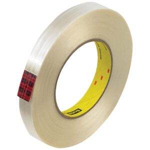 A roll of Scotch® Filament Tape 890MSR, measuring 3/4 x 60 yds, features a plaid red and black label, highlighting its durability. The yellow inner core with black text accents is angled to emphasize the tapes thickness and transparency (sold in cases of 48 rolls).