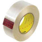 The 12 Pack of Scotch® Filament Tape 890MSR offers clear packaging tape with a yellow core and red/black plaid pattern on the edge. Its glossy finish subtly reflects light, showcasing its quality.