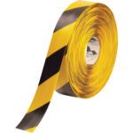 A partly unrolled 2 x 100 roll of Yellow/Black Mighty Line™ Deluxe Safety Tape displays its bold alternating diagonal pattern.