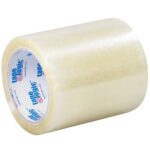 A 5 x 72 yds. Clear Tape Logic® 2 Mil Acrylic Tape, part of a reliable 12/Case, lies on its side with a glossy finish and an interior core featuring tape logic in blue and red text.
