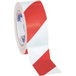 A roll of Tape Logic® Striped Vinyl Safety Tape, measuring 2 x 36 yds., showcases its glossy finish with red and white diagonal stripes. The brand logo is visible inside the partially unrolled tape, available in a convenient Red/White (3 Pack).