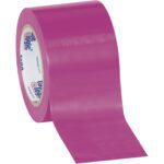 A roll of purple Tape Logic® Solid Vinyl Safety Tape from the 3 x 36 yds. (3 Pack) is artistically unrolling, showcasing its glossy finish and inner core with text, positioned at an angle against a plain white background.