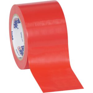 A partially unrolled wide, red tape from the Tape Logic® 3 x 36 yds. Red (3 Pack) Solid Vinyl Safety Tape set features branding inside and a shiny finish.