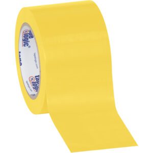 Partially unrolled, the 3 x 36 yds. Tape Logic® Solid Vinyl Safety Tape reveals its glossy yellow surface, with a core displaying white with blue and red logos. Its sold as a convenient (3 Pack) against a plain white background.