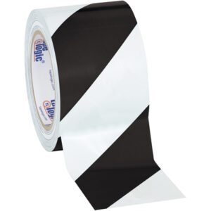 A roll of 3 x 36 yds. Black/White Tape Logic® Striped Vinyl Safety Tape shows its striking diagonal stripes when unrolled. Its available in packs of 16 per case for easy deployment.