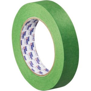 A roll of 1 x 60 yds. Tape Logic® 3200 Green Painters Tape (36 Rolls/Case) is upright on a white surface, revealing its inner side with the TAPE LOGIC brand prominently printed in blue and red on a white background.