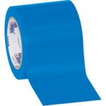 A partially unrolled 4 x 36 yds. Blue Tape Logic® Solid Vinyl Safety Tape (12 Rolls/Case) displays its smooth, glossy surface and inner text on a cardboard circle, lying on a plain white background, showcasing functionality and visibility.